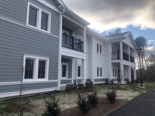 A two-story building with a balcony on the second floor.
