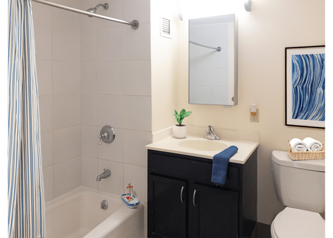 A bathroom with a white sink and a toilet.