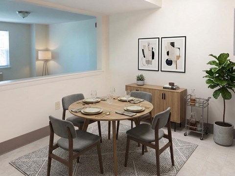 A dining room with a round table set for six.