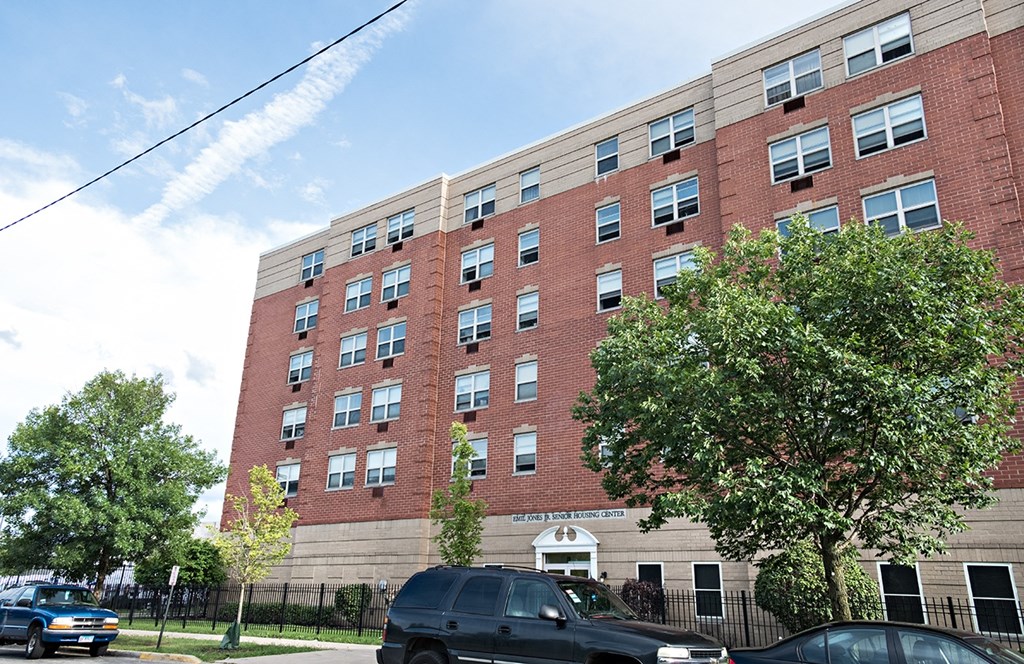 a large brick building with cars parked in front of it