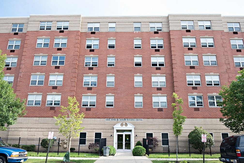 a large brick building with a sidewalk in front of it