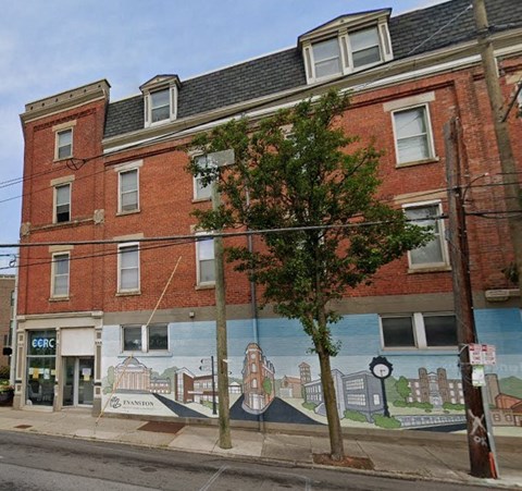 a brick building with a mural on the side of it