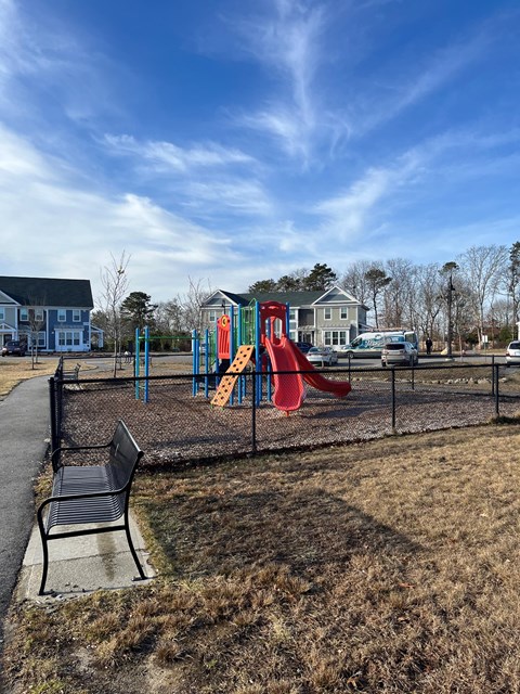 a park with a playground and a bench