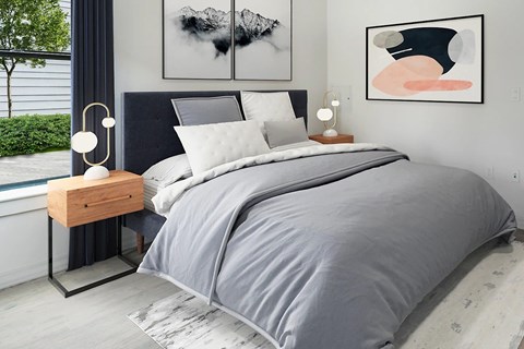 Bedroom with gray bedding and modern artwork at FLAT 9 at WHITTIER Apartments, Boston