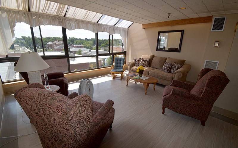 A living room with a couch, chair, and table.