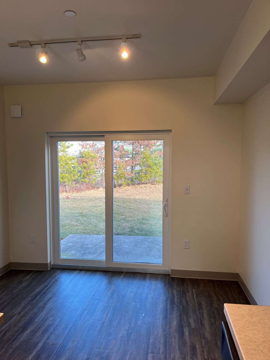 a living room with a large window and a wooden floor