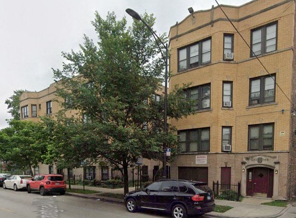 a black car is parked in front of a building