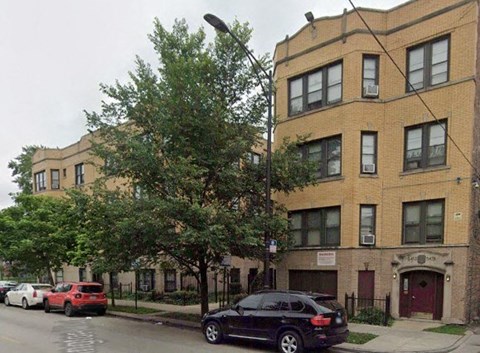 a black car is parked in front of a building