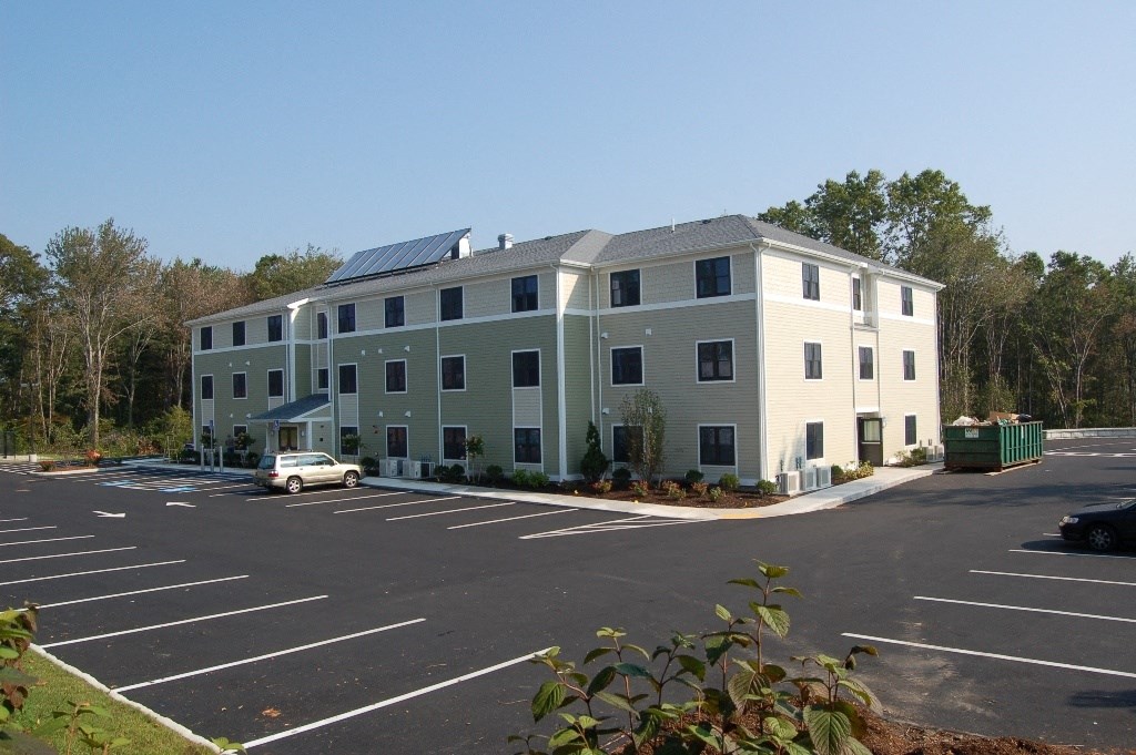 an apartment building with solar panels on the roof