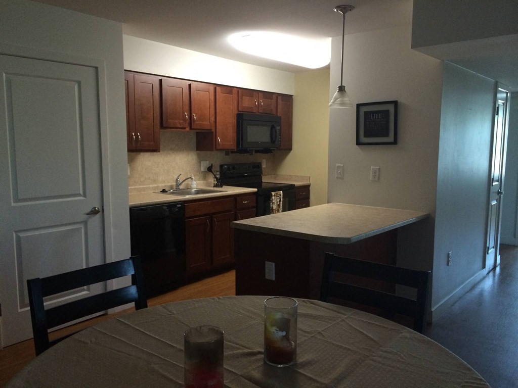 an empty kitchen with a table and chairs in it