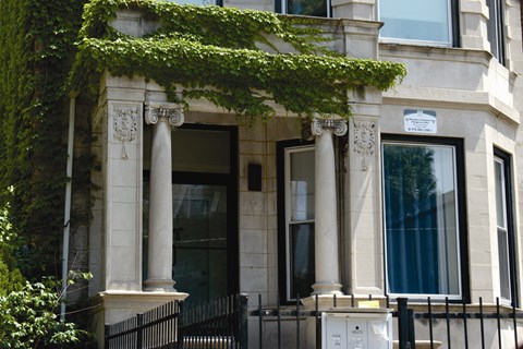 A building with a black iron fence in front of it.