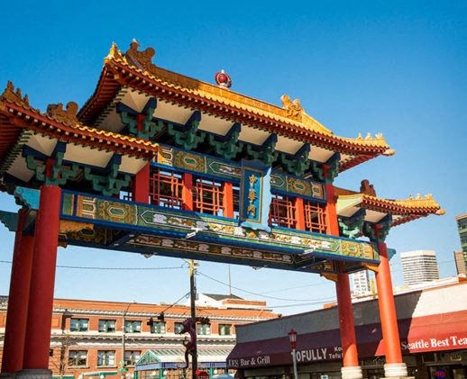 a pagoda in the middle of a city with a building in the background
