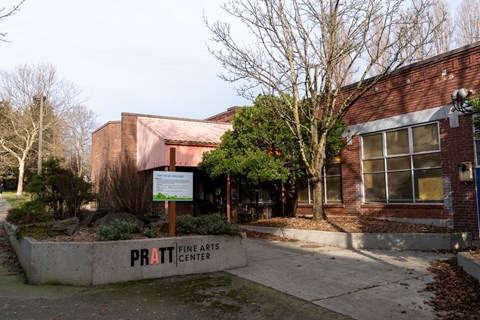 The Pratt Fine Arts Center is a red brick building with a sign in front.