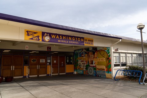 The front of Washington Middle School with a mural on the wall.
