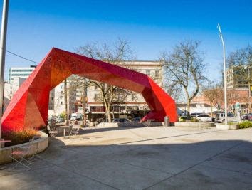 a red sculpture in the middle of a city street