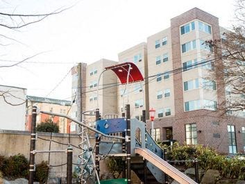 a playground in front of a large building
