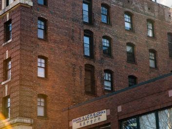 a brick building with a sign in front of it