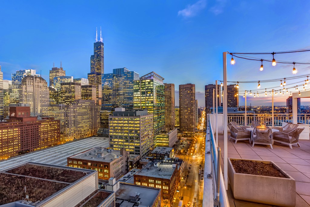 a view of the city skyline from a rooftop terrace