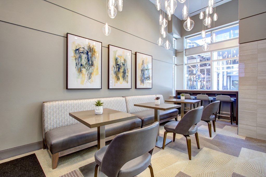 a dining room with tables and chairs and art on the wall