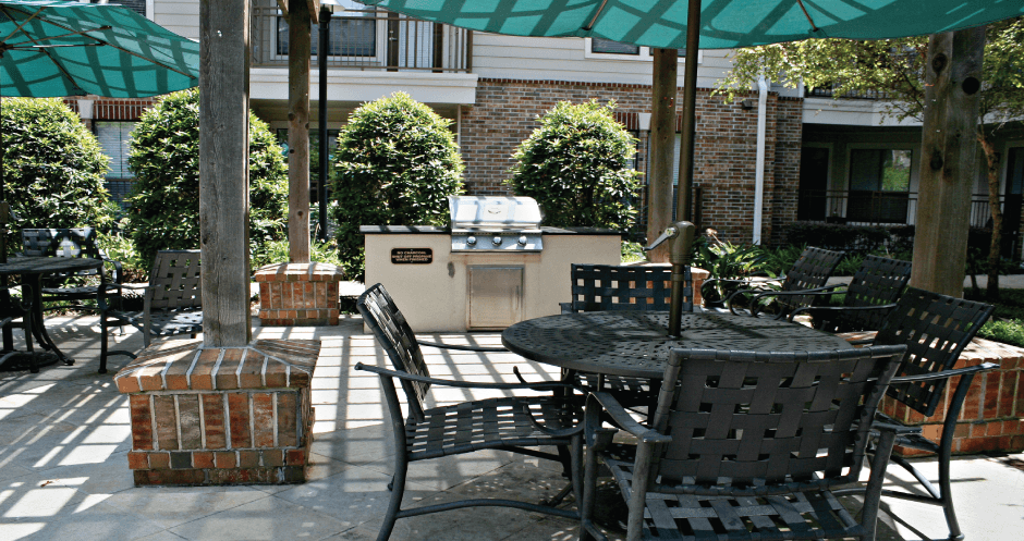 Luxury swimming pool with cabanas, poolside lounges, grilling stations, palm trees and beautiful landscaping at The Voss Apartments in Houston.