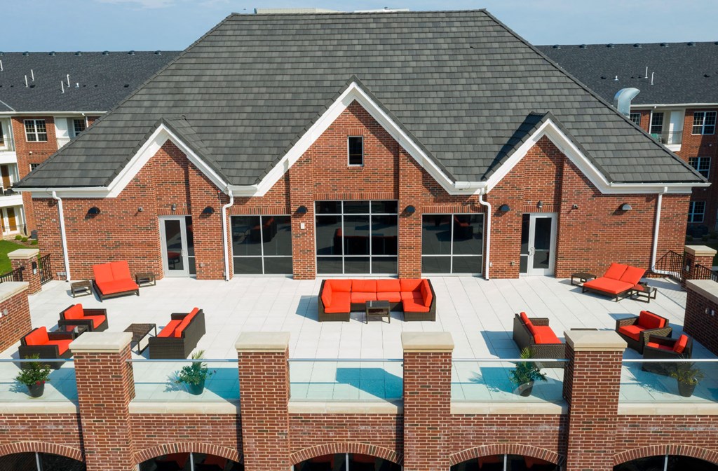 Luxury apartments with brick exteriors, outdoor entertainment lounge with grilling stations, luxury swimming pool, poolside lounges, and manicured gardens at Luxembourg Apartments