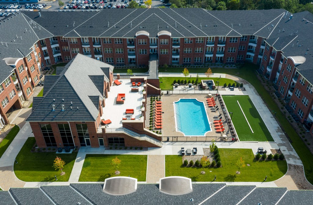 Luxury apartments with multi-level fitness center, outdoor entertainment lounge with grilling stations, luxury swimming pool, poolside lounges, and manicured gardens at Luxembourg Apartments