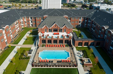 Luxury apartments with multi-level fitness center, outdoor entertainment lounge with grilling stations, luxury swimming pool, poolside lounges, and manicured gardens at Luxembourg Apartments