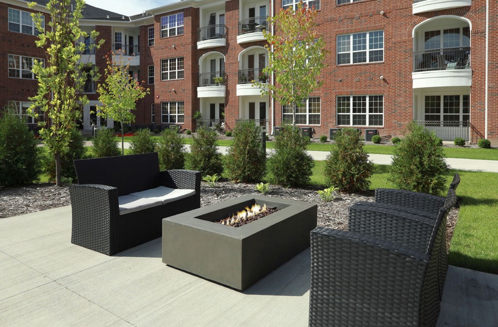 Luxury apartments with brick exteriors, outdoor entertainment lounge with grilling stations, and manicured gardens at Luxembourg Apartments