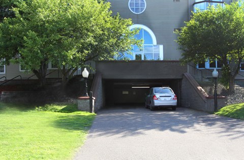 Apartments set in a nature preserve with underground heated parking, windshield wiping station, and controlled access entry at Claremont Apartments in Minnetonka, Minnesota