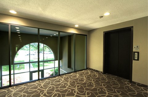 Apartments set in a nature preserve with elevators and controlled access entry at Claremont Apartments in Minnetonka, Minnesota