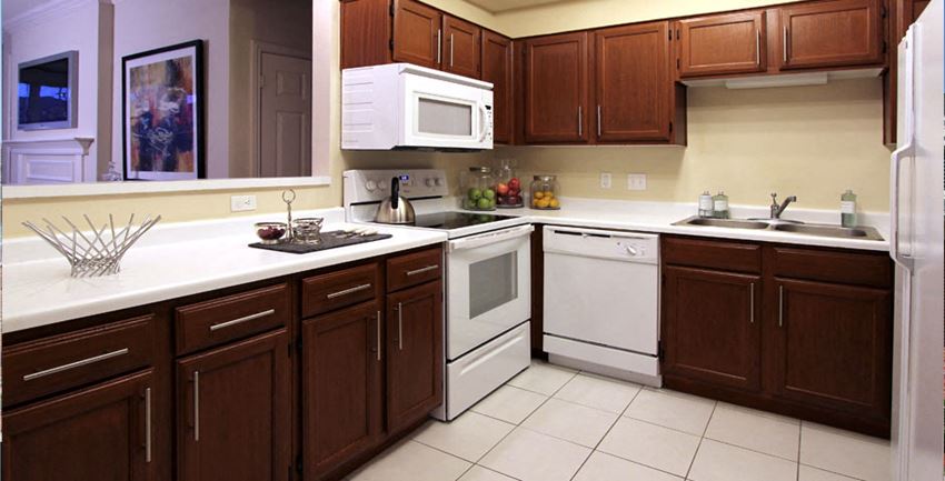 Spacious kitchen with lots of cabinet space, side-by-side refrigerator, porcelain tile floors, and lots of counter space at The Biltmore Apartments in Omaha, Nebraska - Photo Gallery