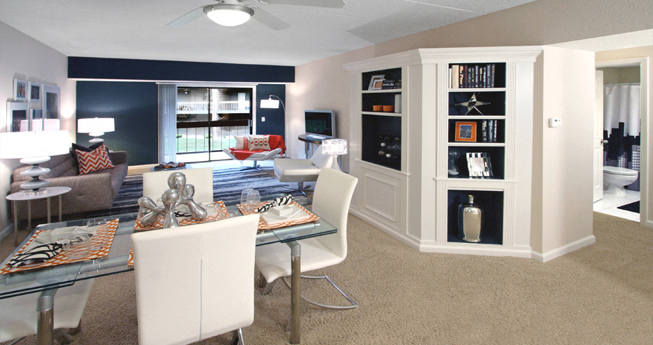 a living room and dining room with a table and chairs