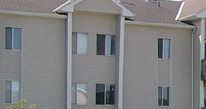 Patio overlooking pool Swimming pool with sundeck and poolside lounge chairs, beautiful landscaping, lush landscaping, apartments with pool view, and park-like setting at Kensington Woods Apartments in Omaha, Nebraska - Photo Gallery