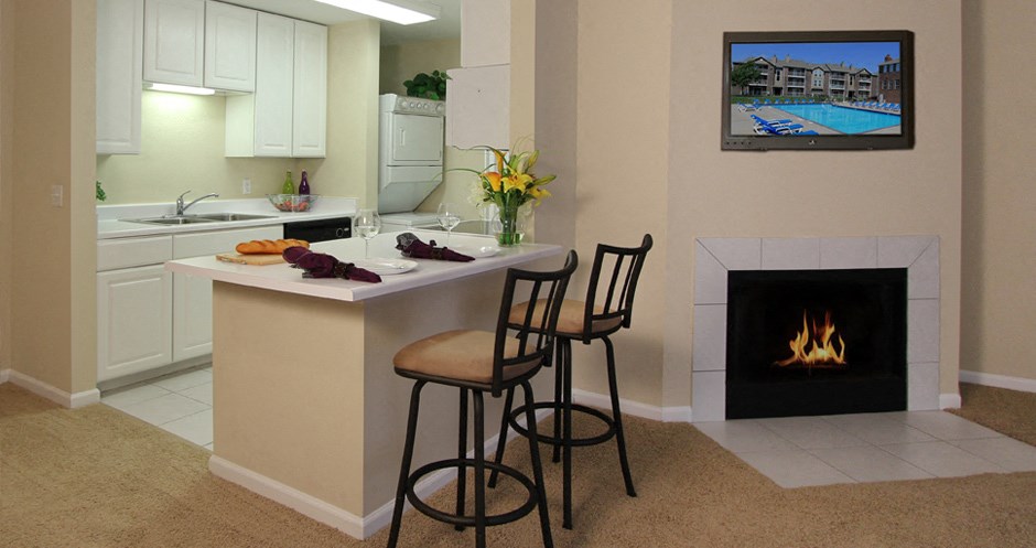 Spacious apartments with woodburning fireplace, breakfast bar, bright white kitchen, extra cabinet space, extra counter space at LionsGate Apartments in Lincoln, Nebraska