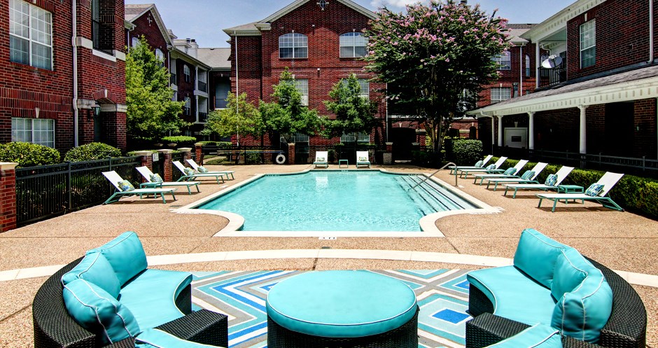 Luxury swimming pool with relaxing sundeck at Tuscany Apartments in Houston.