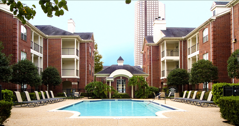 Luxury swimming pool with large sundeck at Tuscany Gate Apartments in Houston.