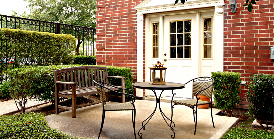 Private backyard patios and red brick exteriors at Tuscany Villas in Houston.