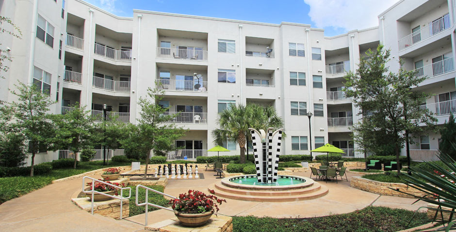 Luxury apartments in the Las Colinas area with a beautiful courtyard, landscaped courtyard, luxury courtyard, fountain, zen garden, and firepit