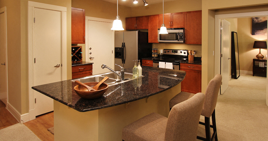 Luxury apartments with hardwood floors, granite countertops, stainless steel appliances, and honey-brown toned cabinets in the Las Colinas area of Irving, Texas