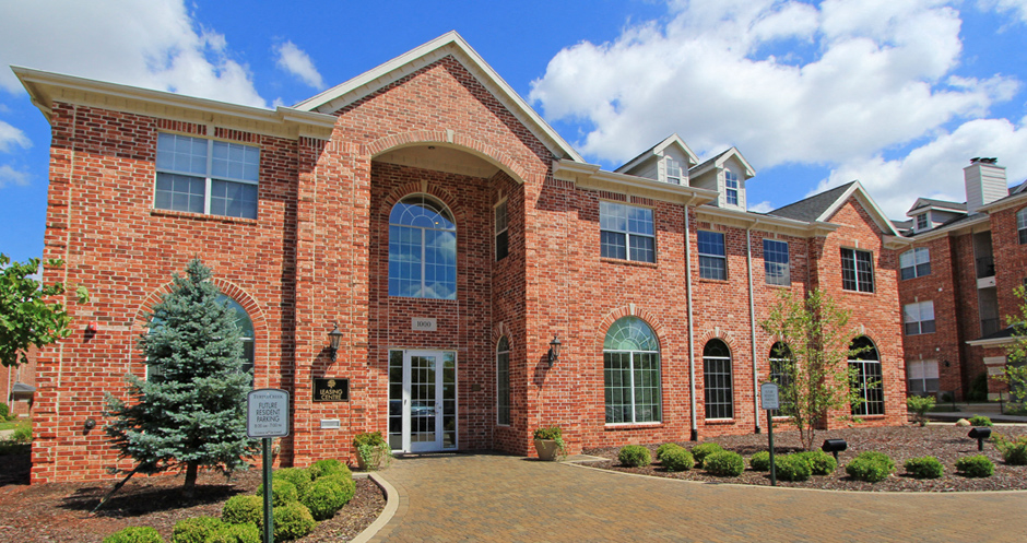 Luxury apartments with red brick exterior and lush landscaping at TurtleCreek apartments in West Des Moines, Iowa