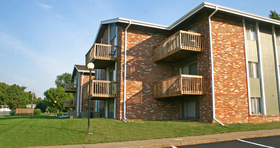 Apartments in La Vista with brick exteriors, park-like setting, scenic views, and lots of trees at The Inverness Apartments