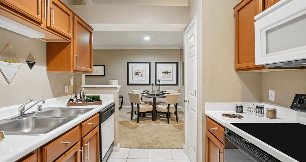A kitchen with brown cabinets and a white countertop.
