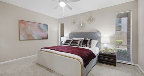 A bedroom with a large bed and a painting on the wall.