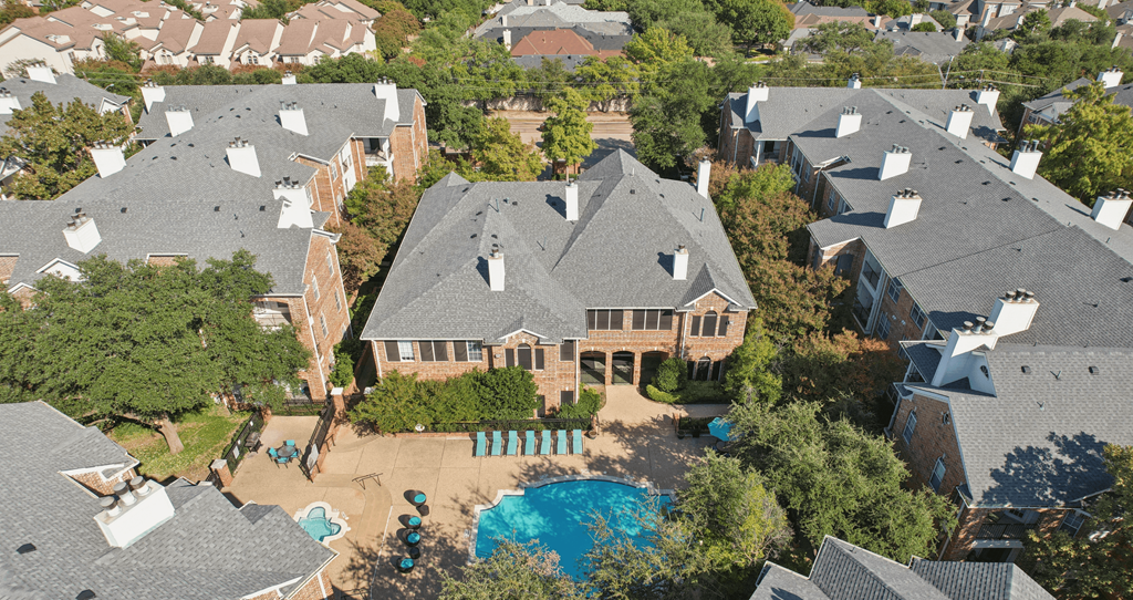 A bird's eye view of a house with a pool in the backyard.