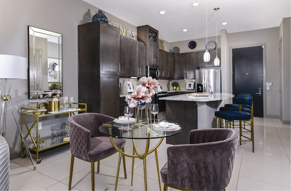 Spacious luxury apartments with porcelain tile floors, dark wood cabinets, and granite countertops at Xenia Apartments in Golden Valley, Minnesota