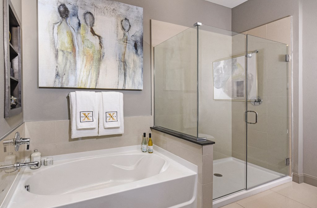 Luxury bathroom with oval soaking tub and glass shower at Xenia Apartments in Golden Valley, Minnesota