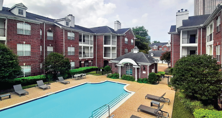 Luxury swimming pool with large sundeck at Tuscany Gate Apartments in Houston.