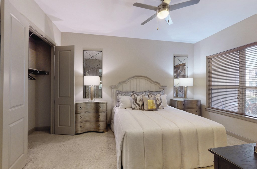 Spacious master bedroom to accommodate a king-size bed and dresser with walk-in closet and master bathroom at Tuscany Walk Apartments in Houston Texas.