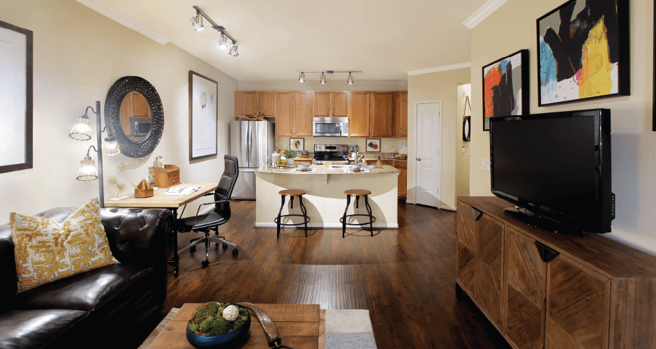 Luxury apartments with spacious open floor plan, hardwood floors, granite countertops, and stainless appliances at The Voss Apartments in Houston.