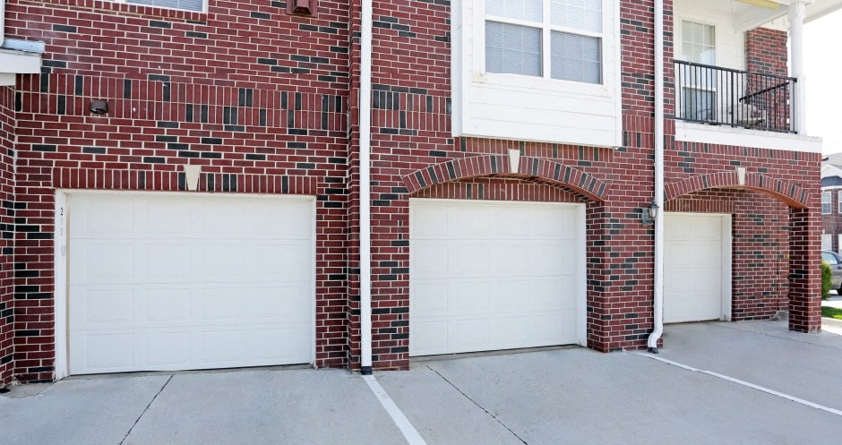 Luxury townhomes with attached garages and red brick exterior next to Rockledge Shopping Center in South Lincoln Nebraska